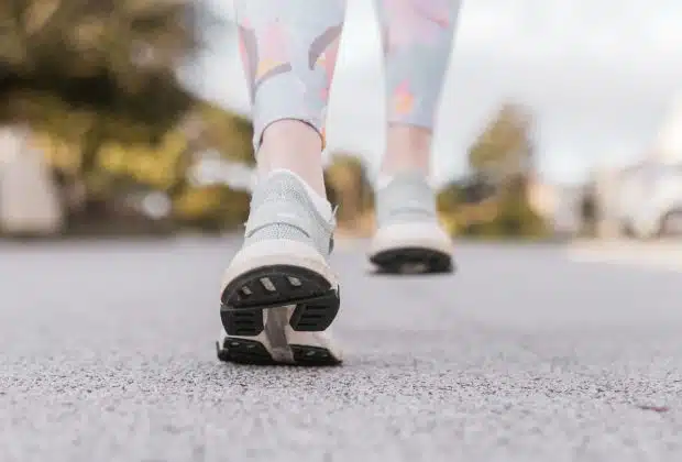 person in white and black nike shoes